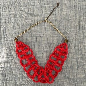 Red crisscross necklace with gold colored chain